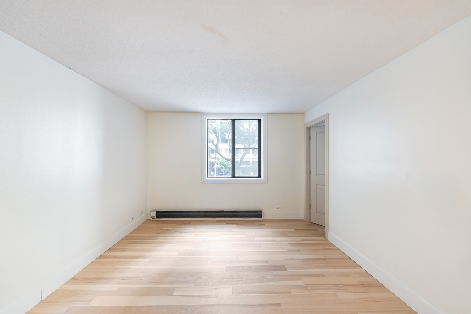 1339 North Dearborn Street, Unit 2B Chicago, IL 60610 - Photo 15 of 20 an empty room with wooden floor and windows