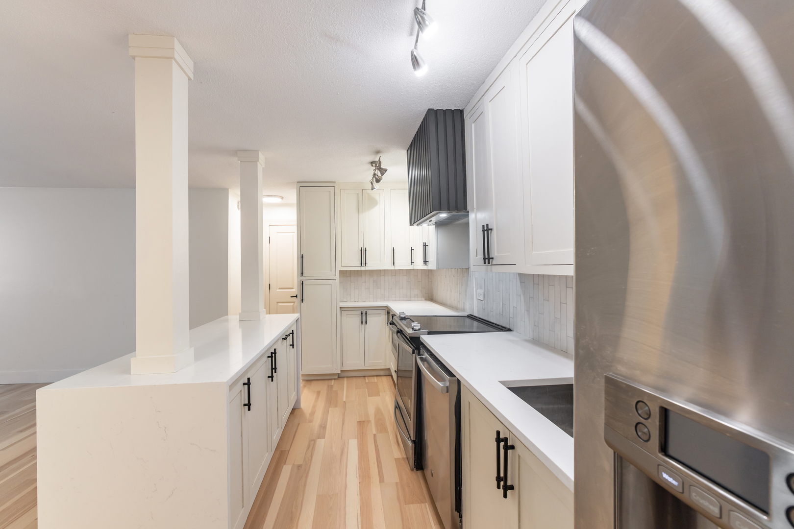 1339 North Dearborn Street, Unit 2B Chicago, IL 60610 - Photo 4 of 20 a kitchen with a sink stove and cabinets