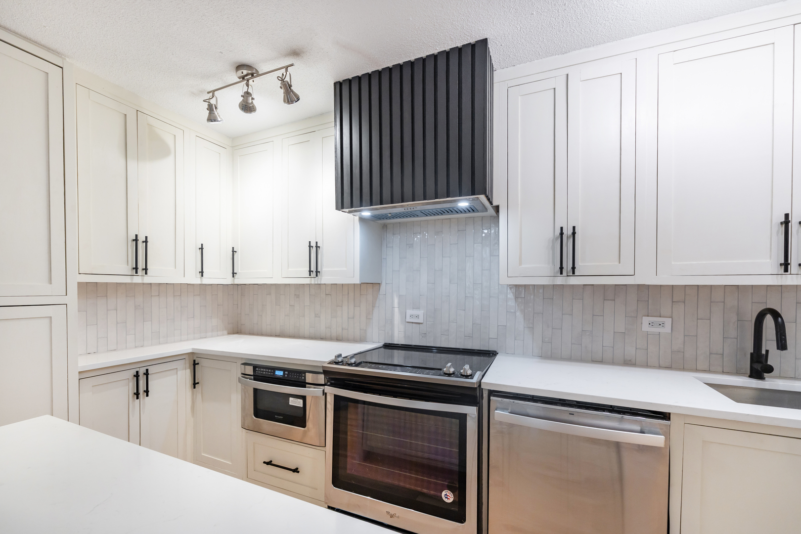 1339 North Dearborn Street, Unit 2B Chicago, IL 60610 - Photo 5 of 20 a kitchen with granite countertop a sink a stove and cabinets