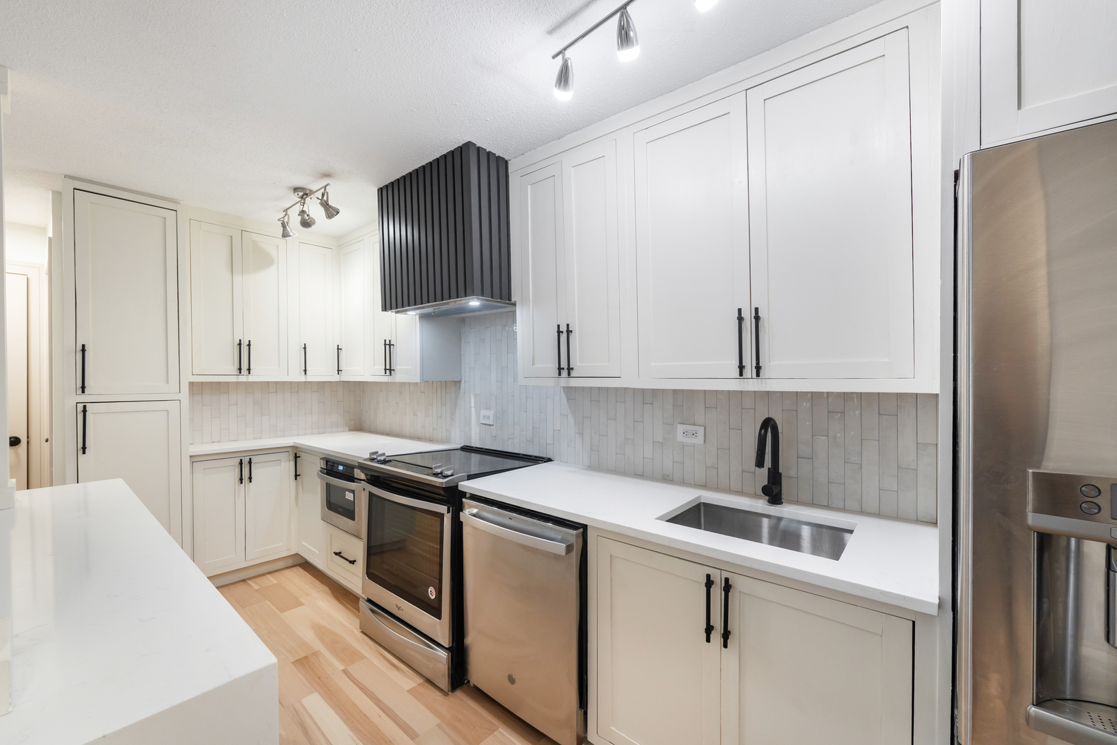 1339 North Dearborn Street, Unit 2B Chicago, IL 60610 - Photo 6 of 20 a kitchen with a sink stove and refrigerator