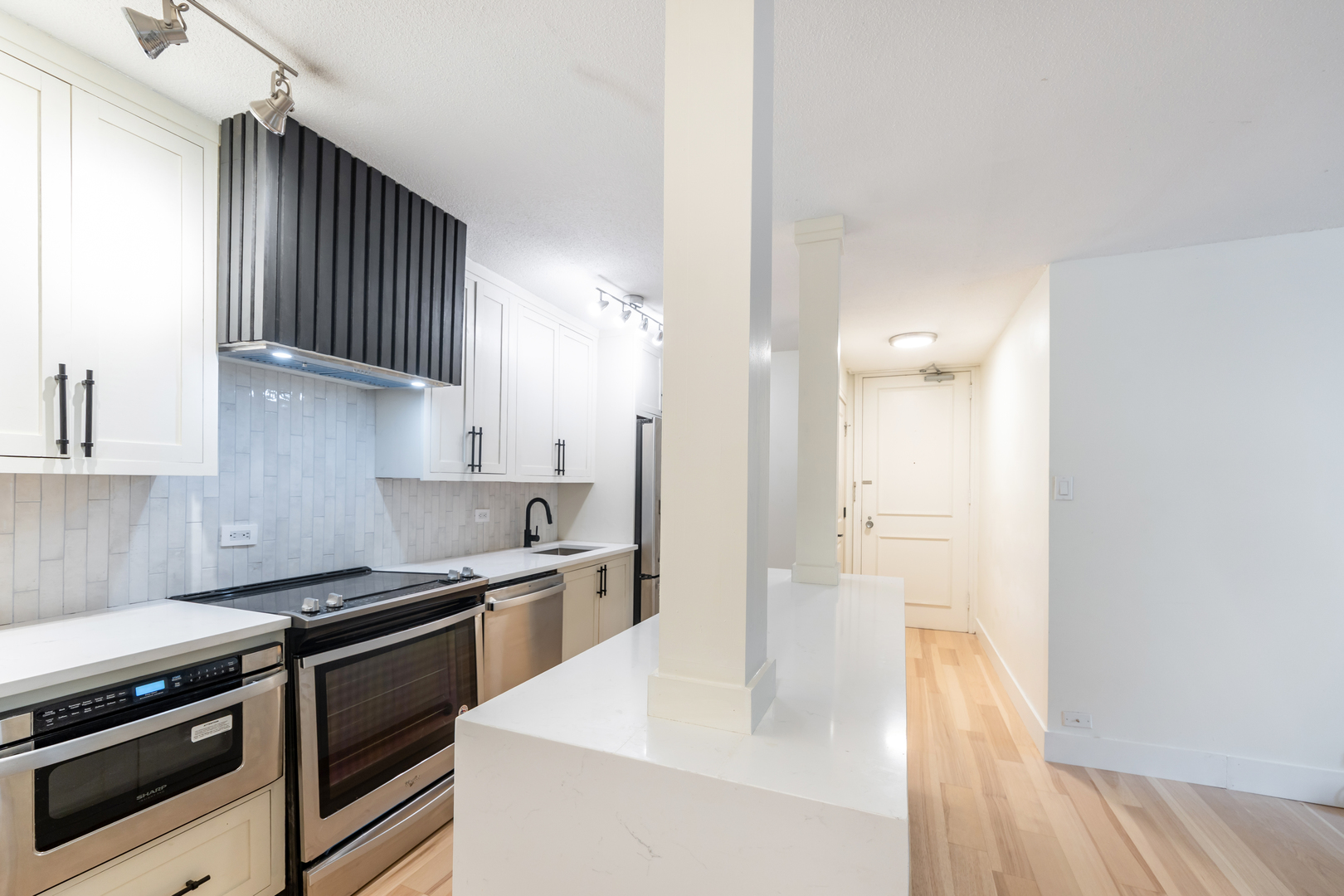 1339 North Dearborn Street, Unit 2B Chicago, IL 60610 - Photo 7 of 20 a kitchen with stainless steel appliances a sink stove and cabinets