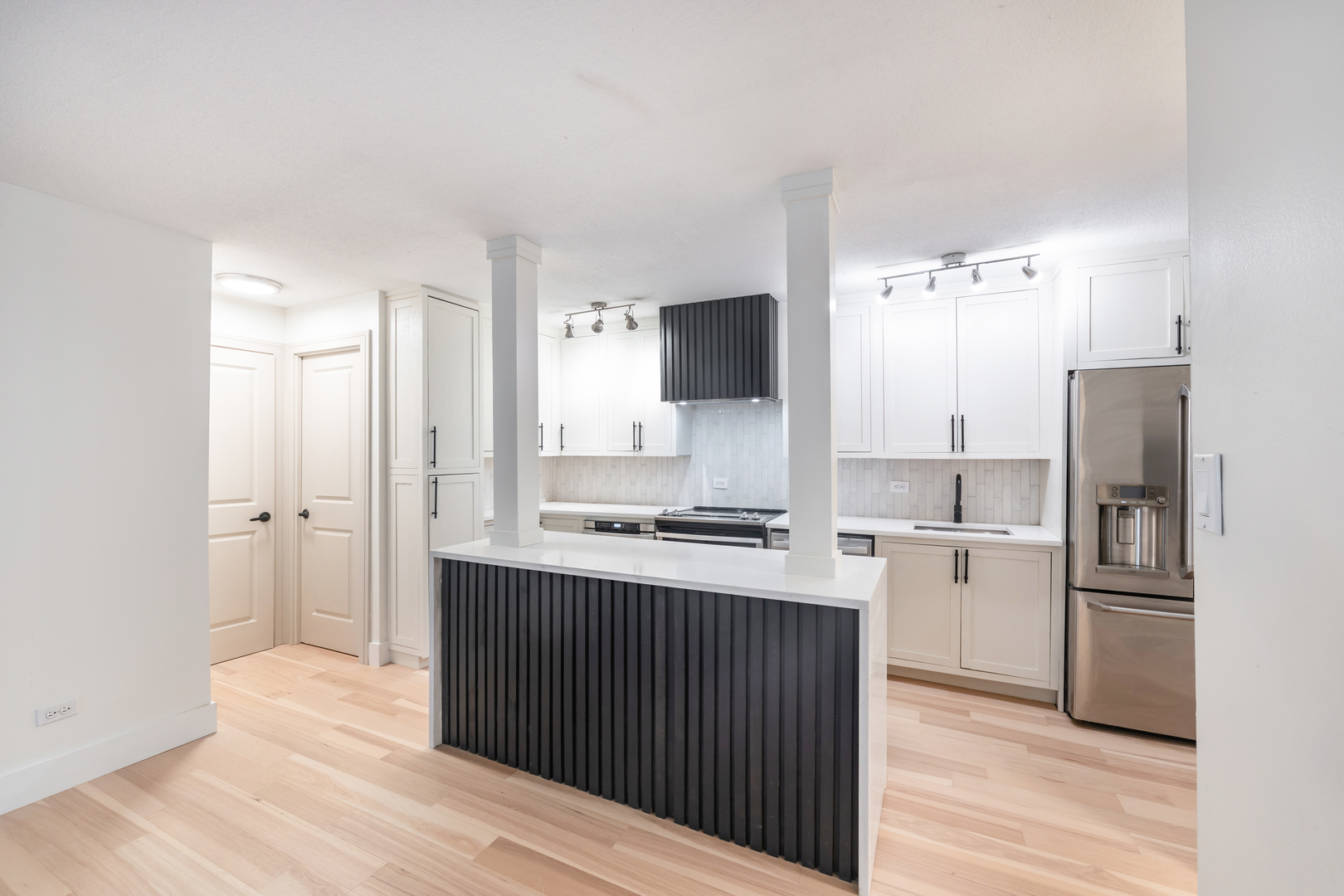 1339 North Dearborn Street, Unit 2B Chicago, IL 60610 - Photo 8 of 20 a kitchen with a refrigerator and a stove top oven