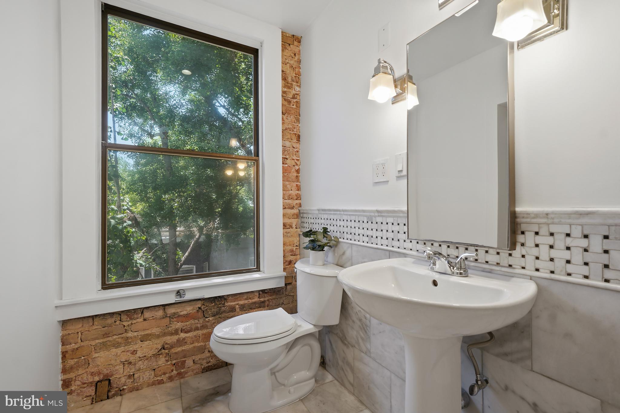 1822 15th Street Northwest, Unit 303 Washington, DC 20009 - Photo 17 of 22 a bathroom with a sink and a mirror
