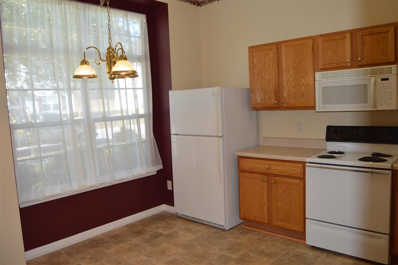 3941 Tyler Bluff Lane Raleigh, NC 27616 - Photo 3 of 9 a kitchen with a refrigerator a stove and a window