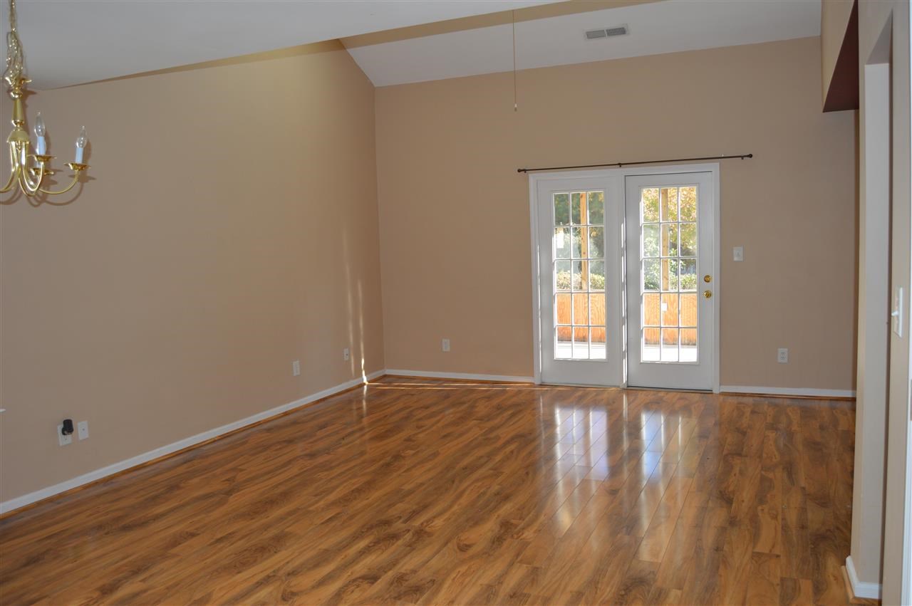 3941 Tyler Bluff Lane Raleigh, NC 27616 - Photo 5 of 9 a view of an empty room with wooden floor and a window