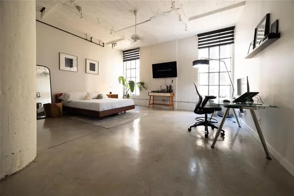 a living room with furniture a flat screen tv and a window