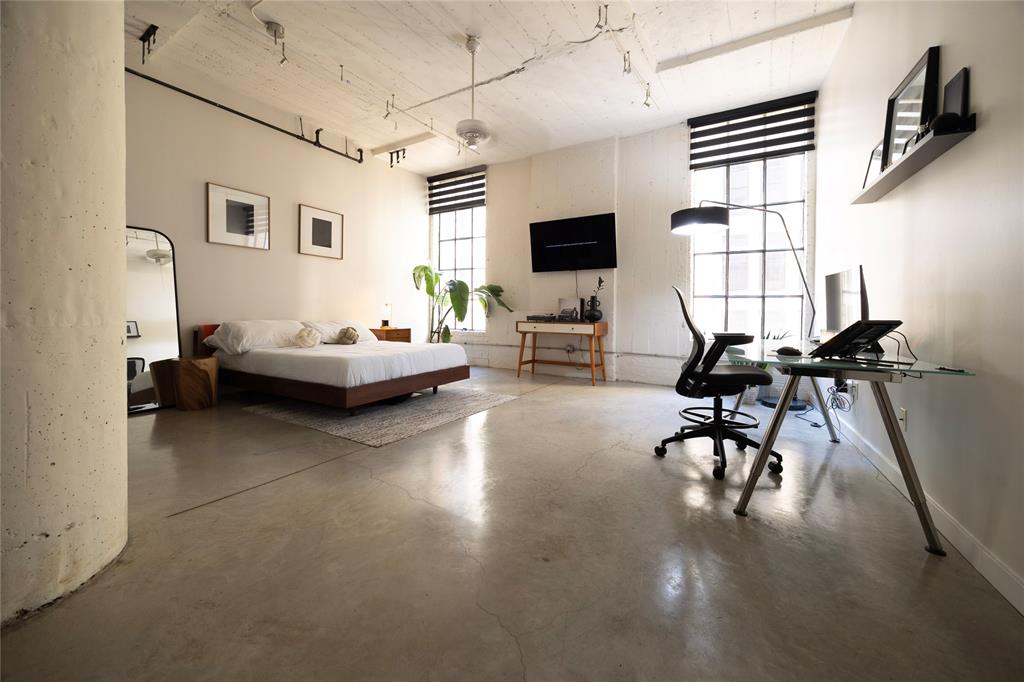 a living room with furniture a flat screen tv and a window
