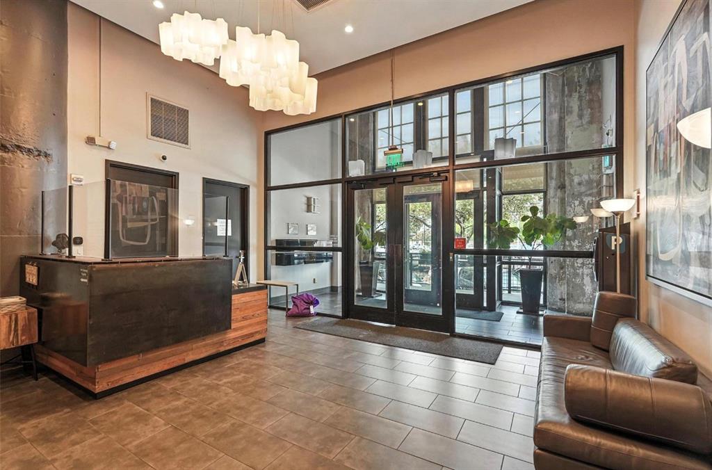 1122 Jackson Street, Unit 618 Dallas, TX 75202 - Photo 14 of 17 a living room with furniture and a chandelier