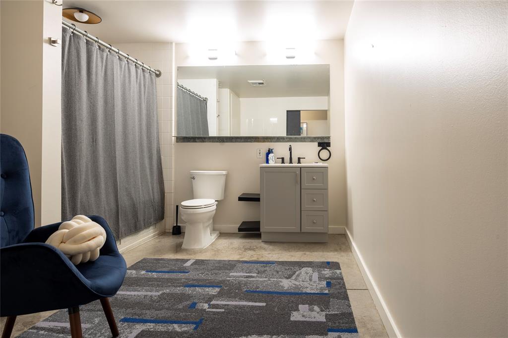 1122 Jackson Street, Unit 618 Dallas, TX 75202 - Photo 7 of 17 a view of bathroom with shower and toilet