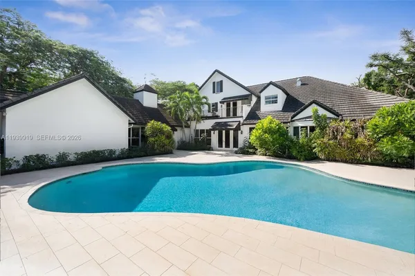 a view of a house with a small yard and a garden