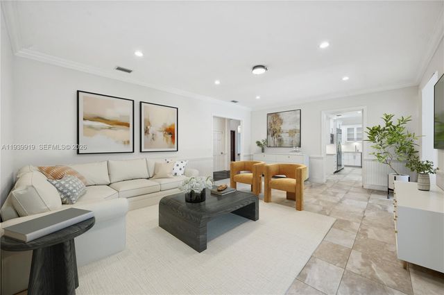 a living room with furniture and a painting