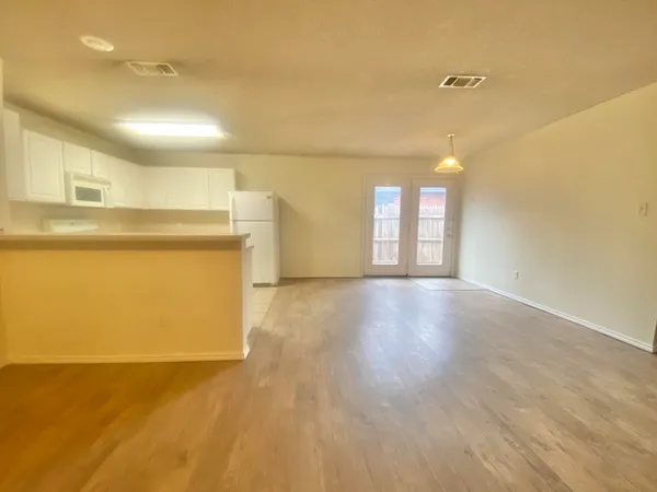 a view of a kitchen with a dishwasher and a refrigerator