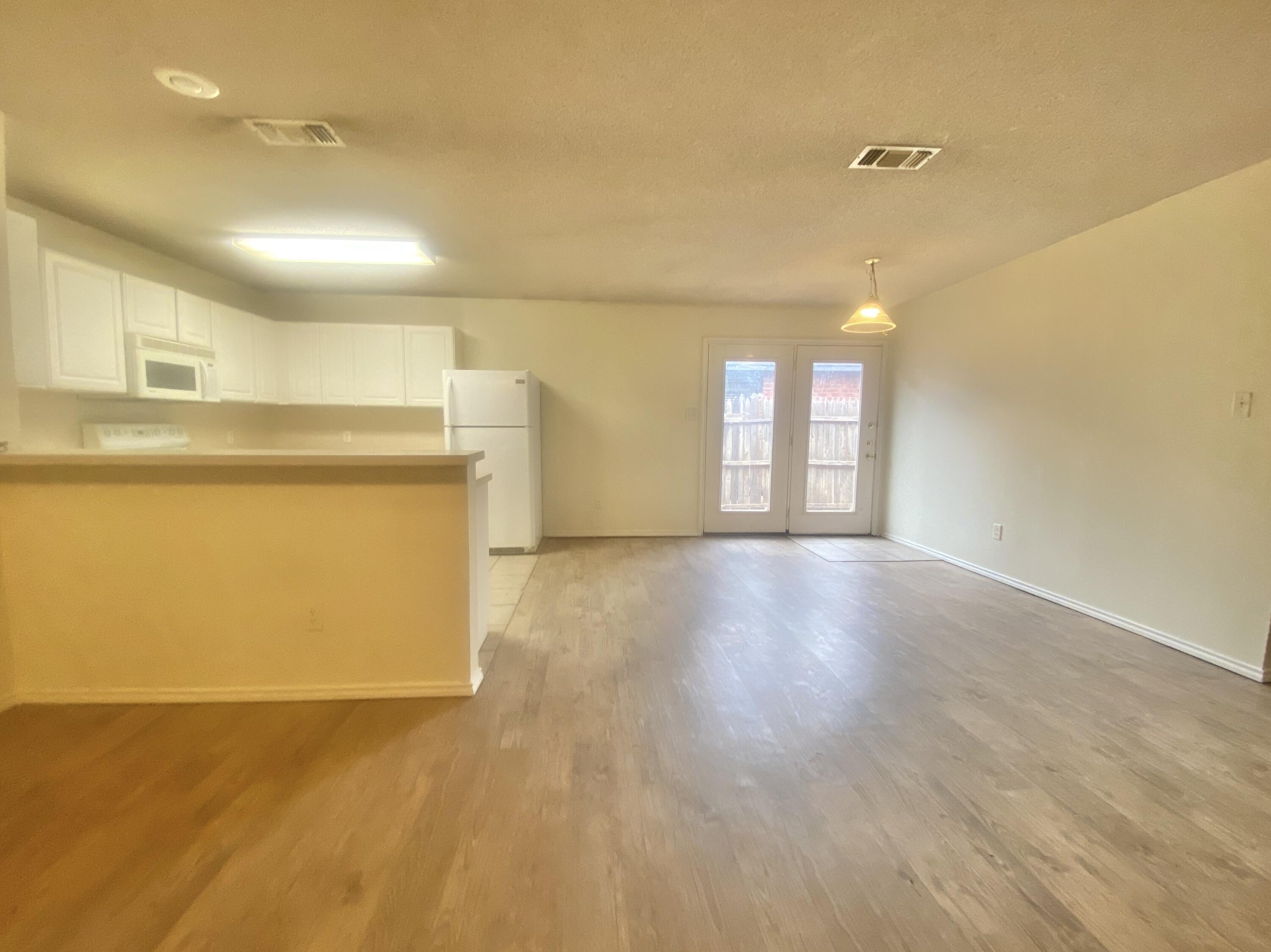 6320 7th Street Lubbock, TX 79416 - Photo 4 of 14 a view of a kitchen with a dishwasher and a refrigerator