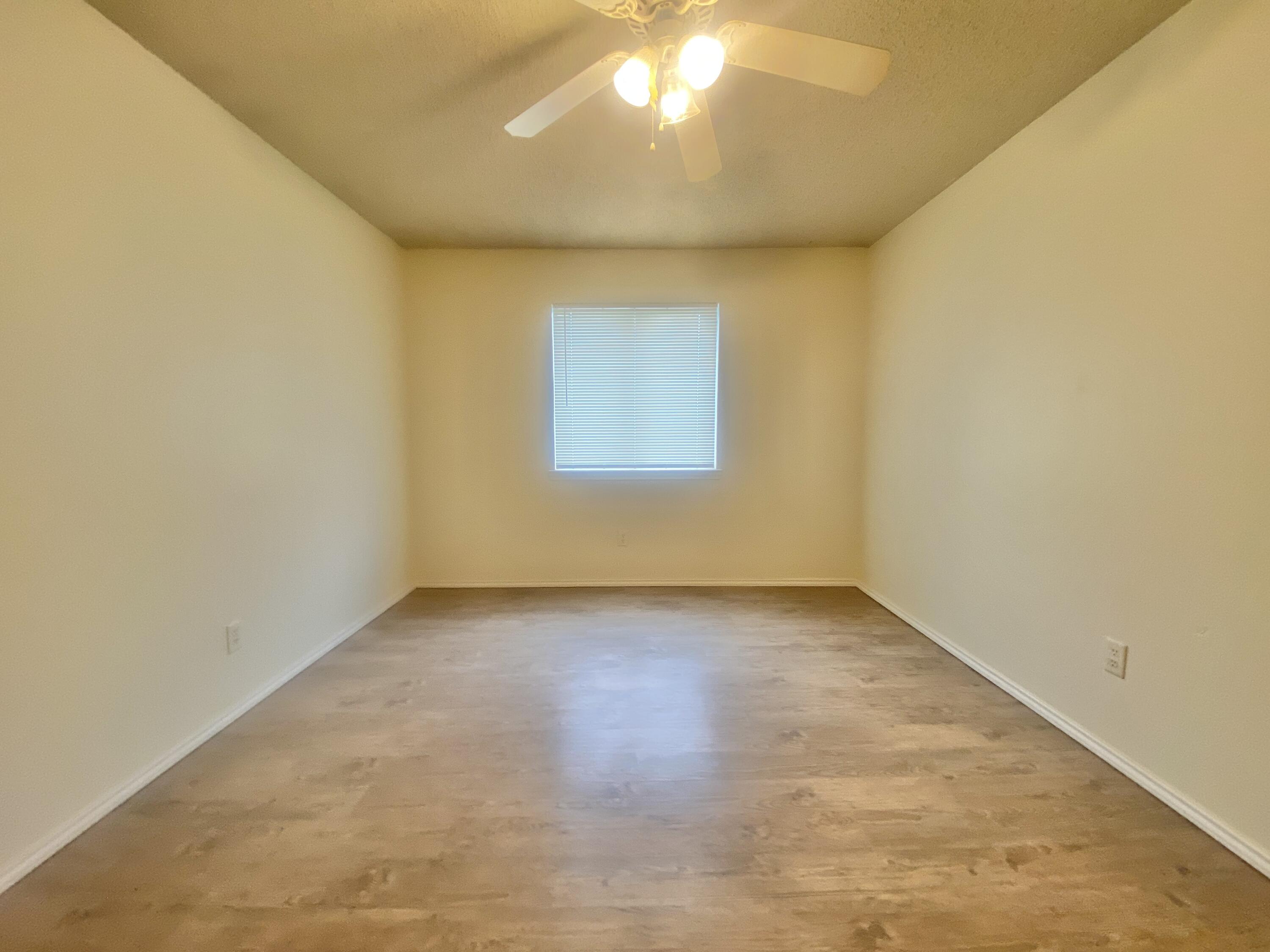 6320 7th Street Lubbock, TX 79416 - Photo 9 of 14 an empty room with a window