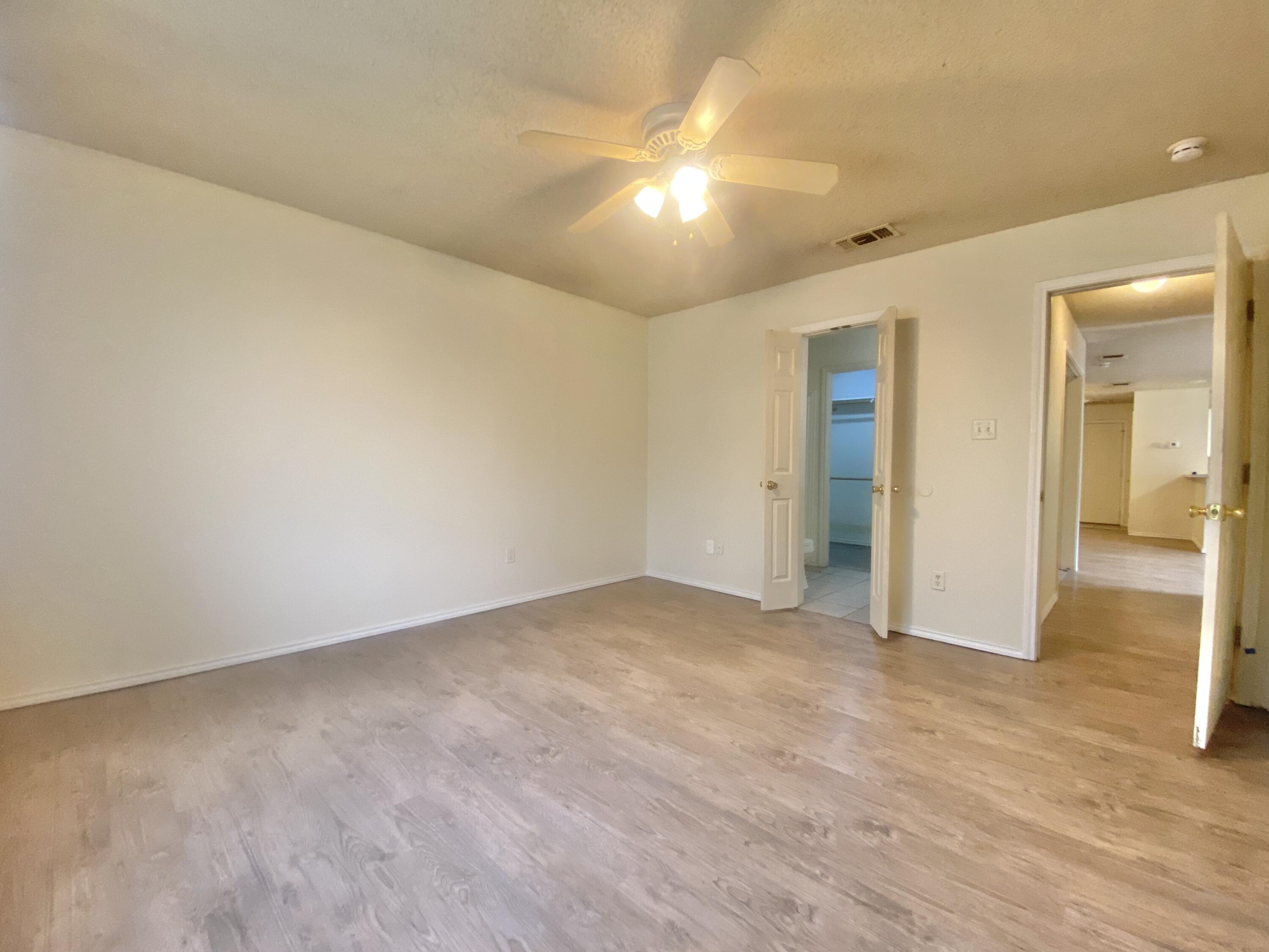 6320 7th Street Lubbock, TX 79416 - Photo 10 of 14 wooden floor in an empty room