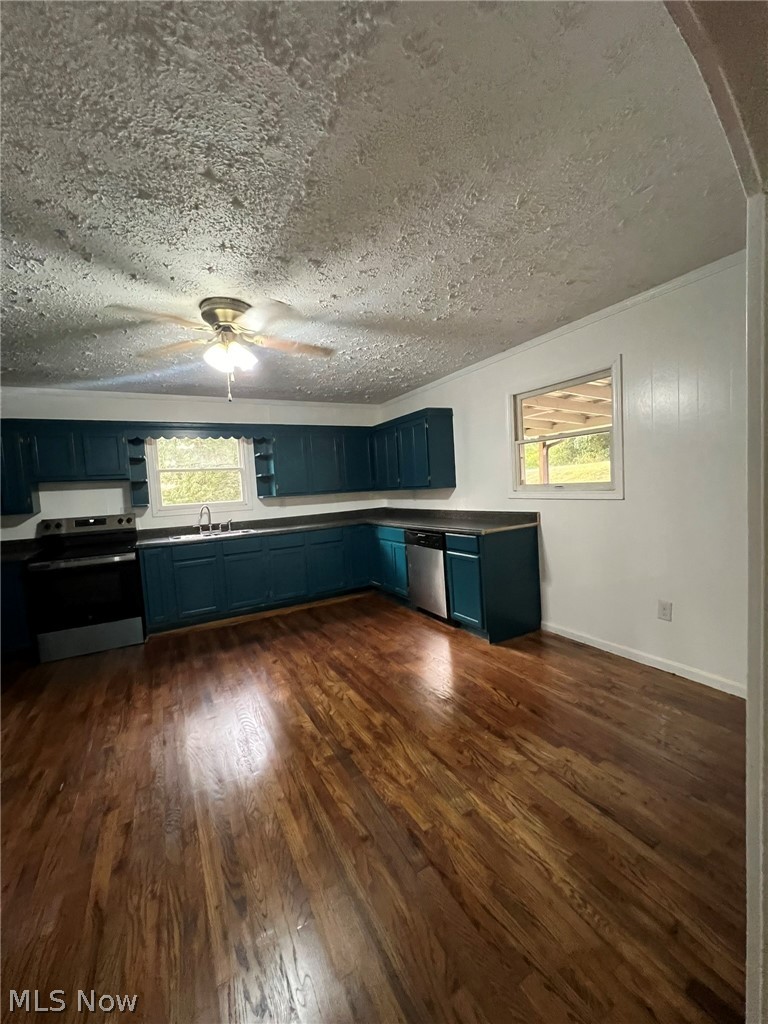 1105 Dutch Ridge Road Guysville, OH 45735 - Photo 5 of 33 Kitchen featuring wood-finish flooring, teal cabinetry, and a ceiling fan with integrated lighting