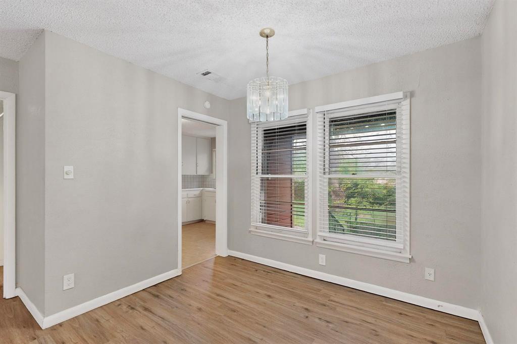 4508 Rutland Avenue Fort Worth, TX 76133 - Photo 12 of 36 a view of an empty room with wooden floor and a window