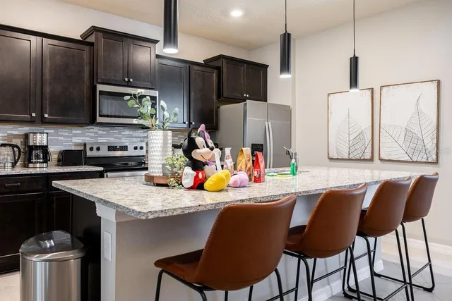 a bedroom with a bed and a potted plant on dresser