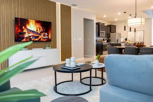 a large bed sitting in a bedroom next to a window and a chair