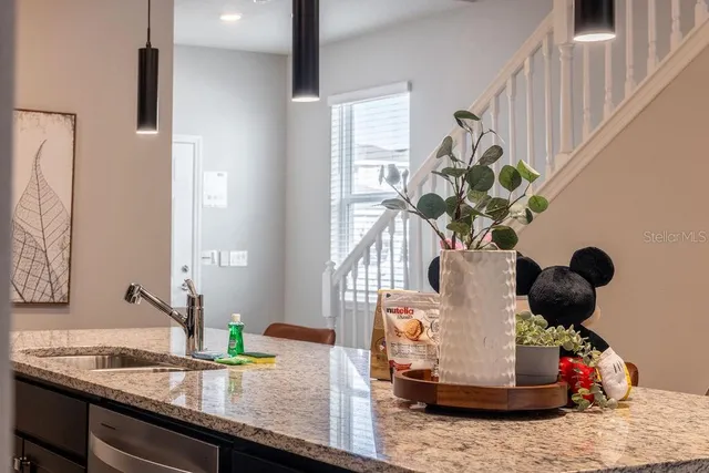 a living room with furniture a lamp and a flat screen tv