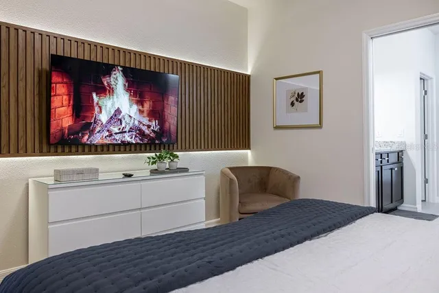 a bed sitting in a bedroom next to a window