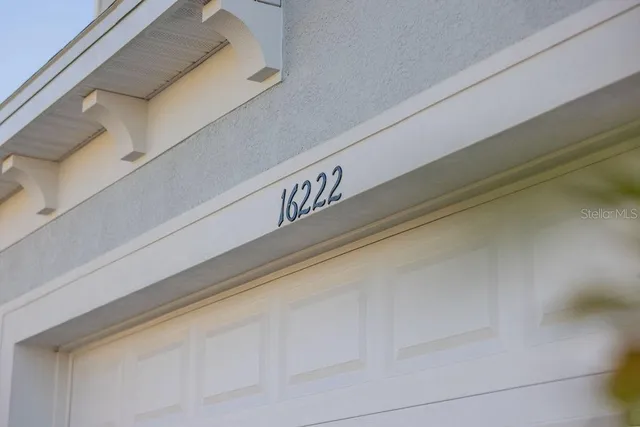a kitchen with stainless steel appliances granite countertop a sink a stove and a wooden cabinets