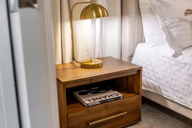 a bathroom with a granite countertop sink two mirror and shower