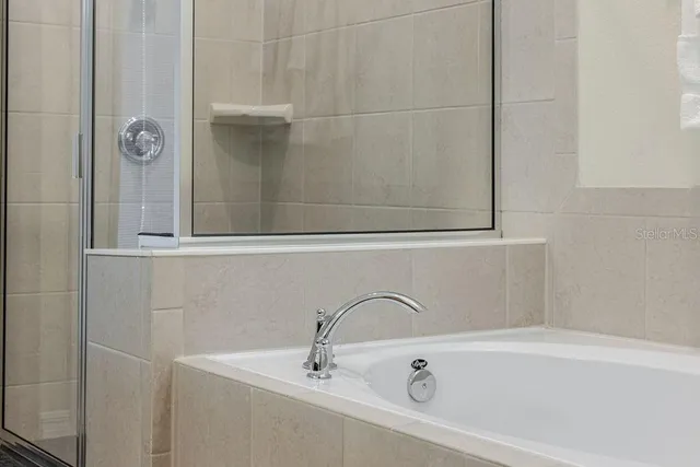 a bedroom with a bed and a wall painting