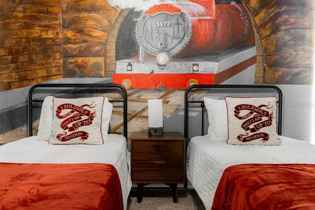 a bedroom with a bed and a chair