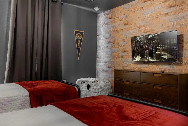 a bedroom with a bed and a flat screen tv
