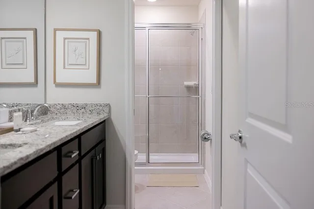 a living room with furniture a chandelier and a floor to ceiling window