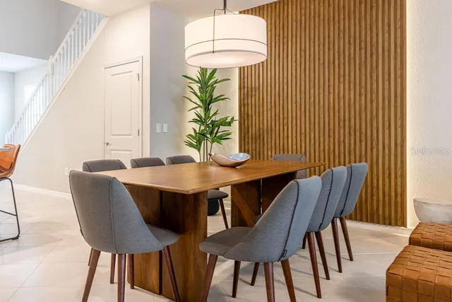a living room with furniture a lamp and a potted plant