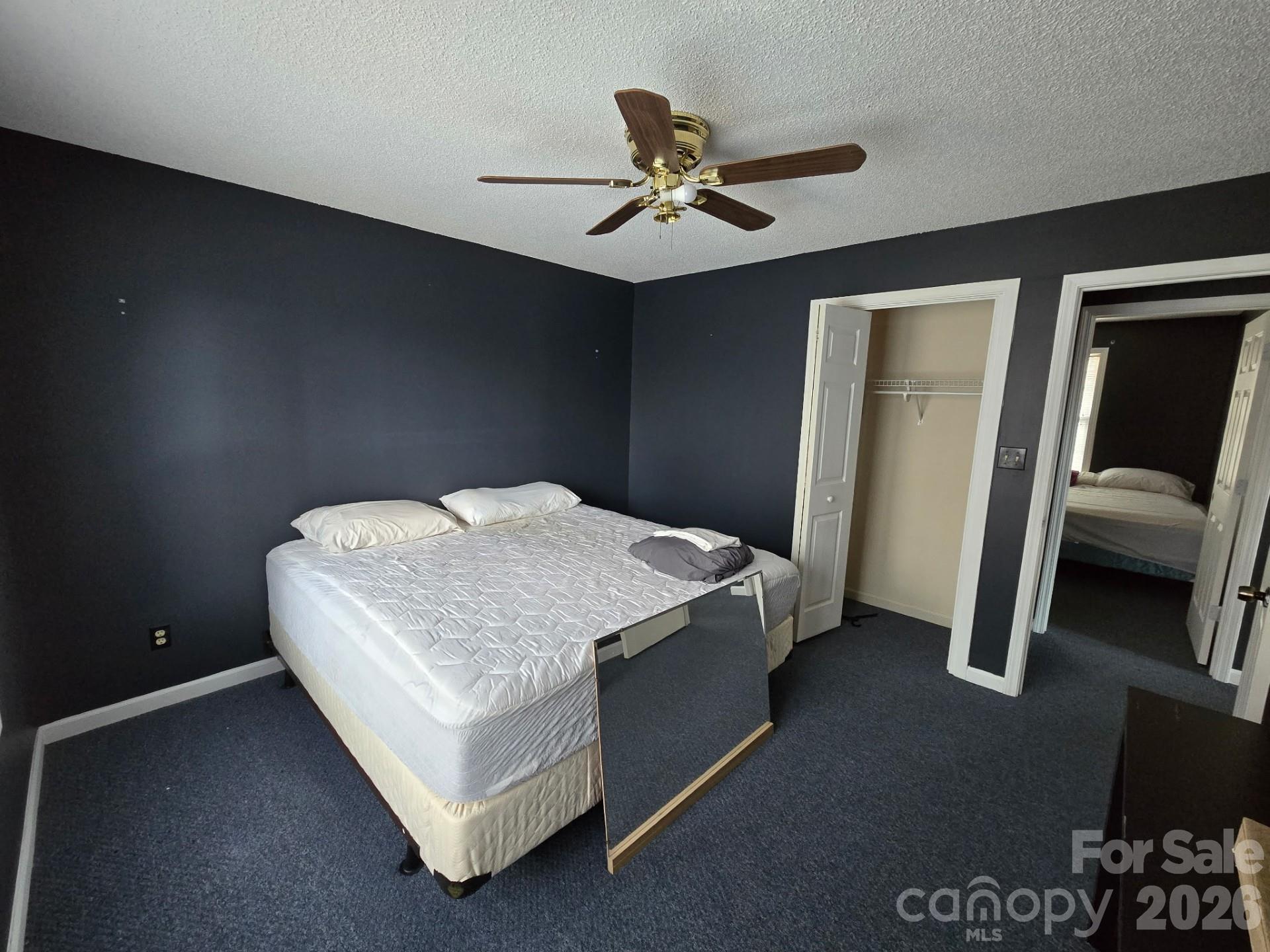 987 W Road Hot Springs, NC 28743 - Photo 6 of 10 a bedroom with a bed and a ceiling fan