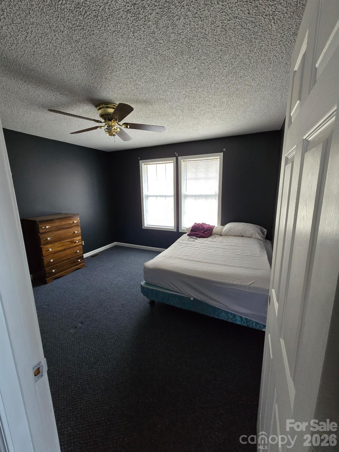 987 W Road Hot Springs, NC 28743 - Photo 7 of 10 a bedroom with a bed and a chandelier