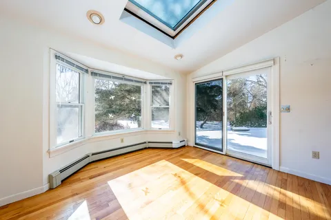 a view of outdoor space with wooden floor and windows