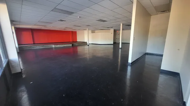 a view of a room with wooden floors