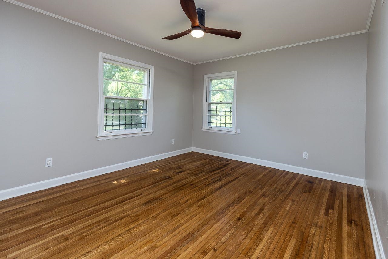 1243 Dearing Road Memphis, TN 38117 - Photo 11 of 25 a view of an empty room with wooden floor and a window