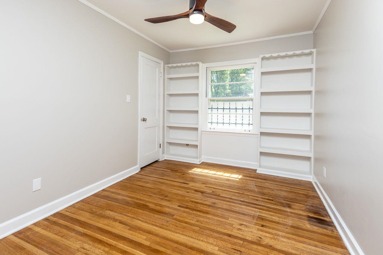 1243 Dearing Road Memphis, TN 38117 - Photo 12 of 25 a view of empty room with wooden floor and fan
