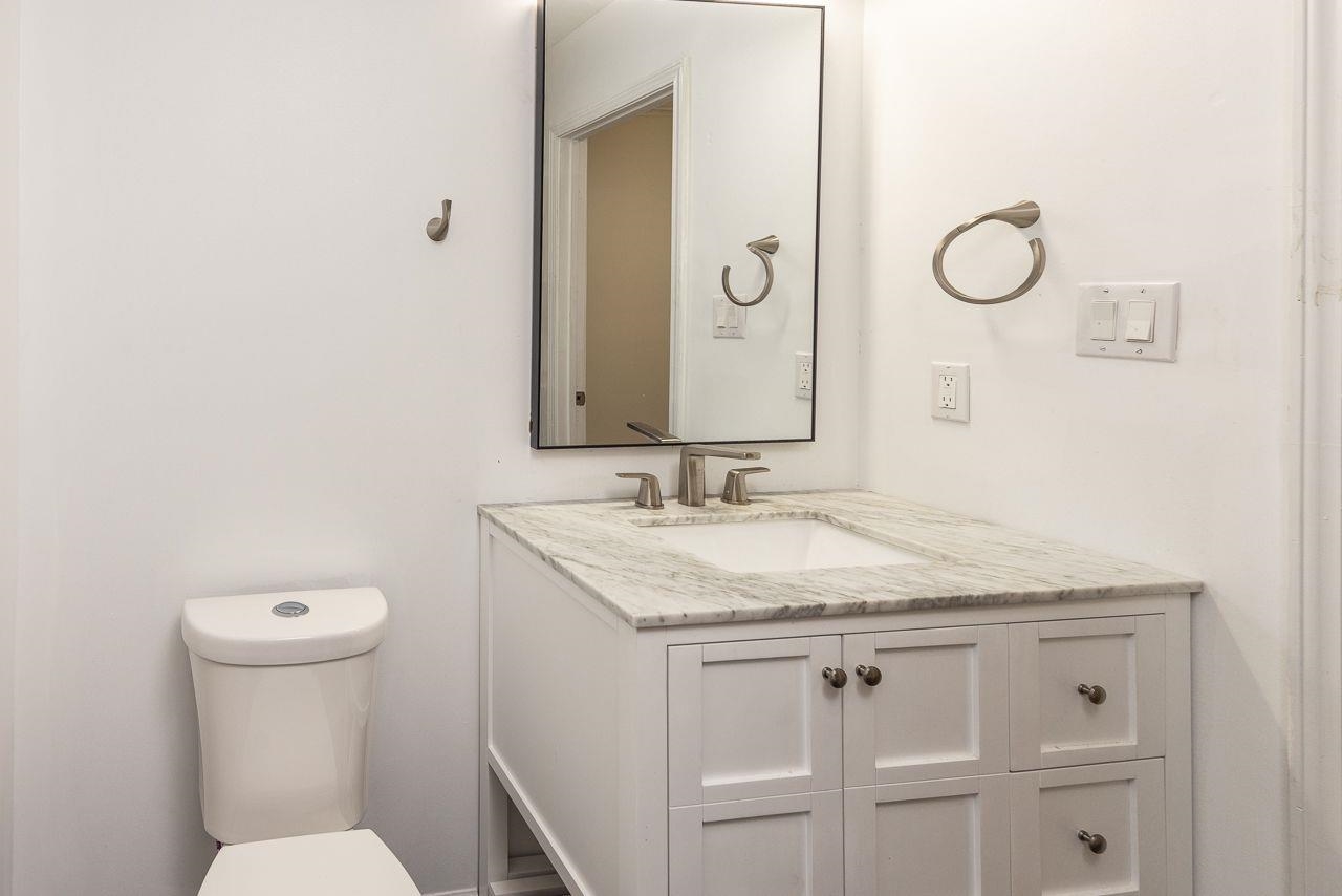 1243 Dearing Road Memphis, TN 38117 - Photo 13 of 25 a bathroom with a granite countertop sink and a mirror
