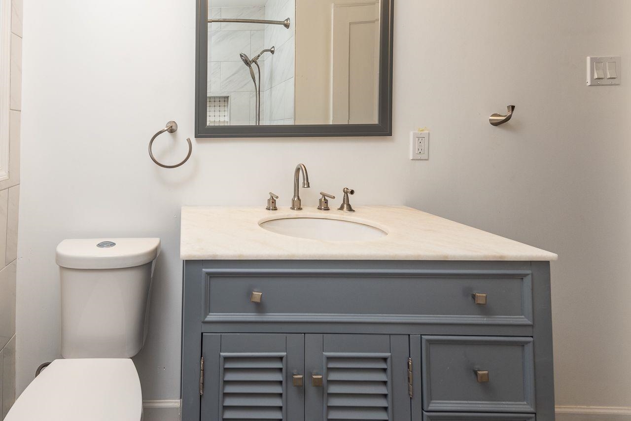 1243 Dearing Road Memphis, TN 38117 - Photo 15 of 25 a bathroom with a sink a toilet and vanity