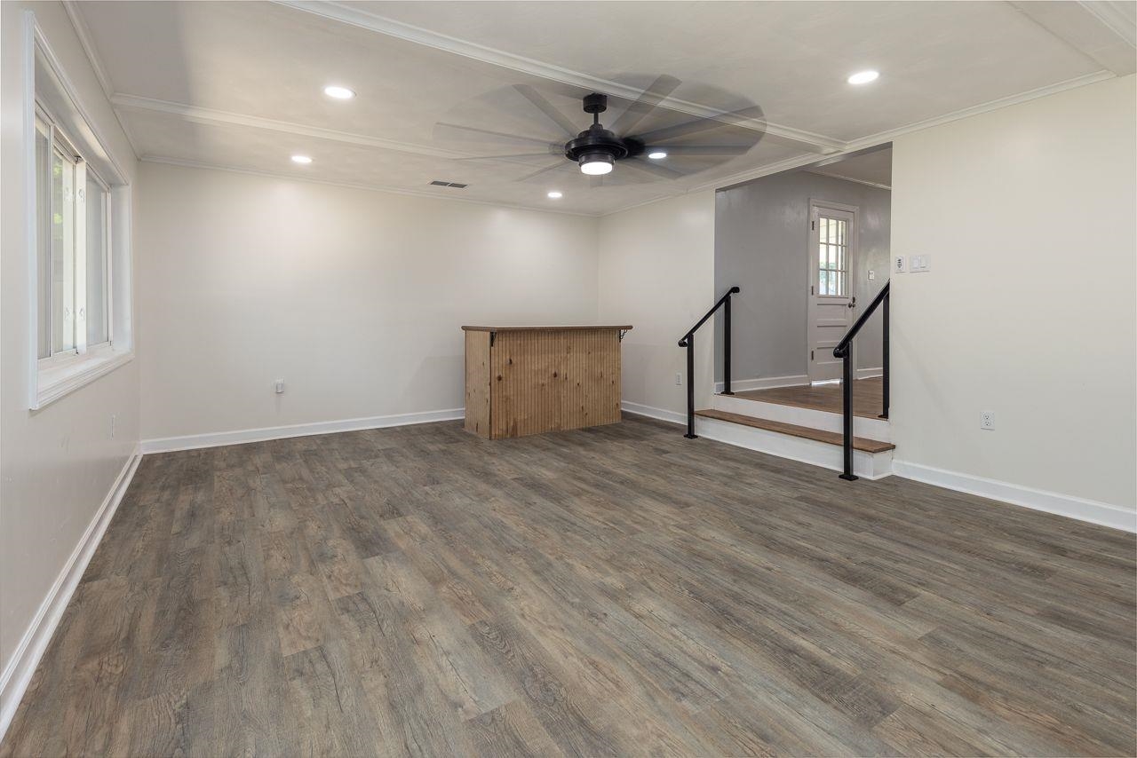 1243 Dearing Road Memphis, TN 38117 - Photo 18 of 25 a view of an empty room with wooden floor and a window