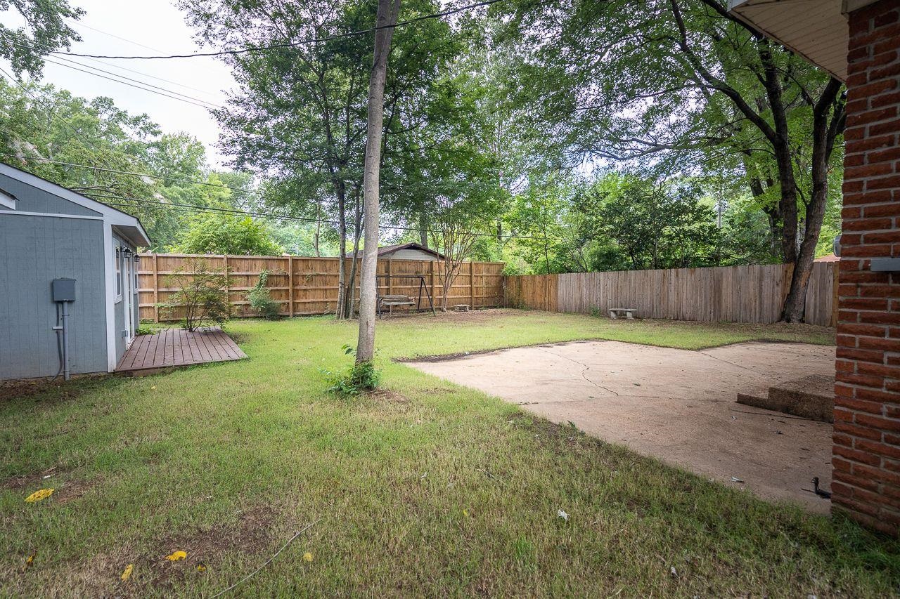 1243 Dearing Road Memphis, TN 38117 - Photo 23 of 25 a view of a backyard with a small cabin
