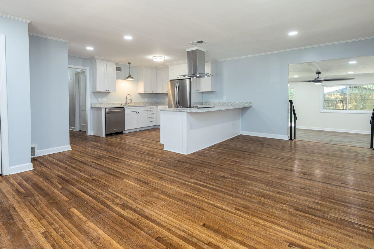 1243 Dearing Road Memphis, TN 38117 - Photo 4 of 25 a large kitchen with stainless steel appliances wooden floor and a large window