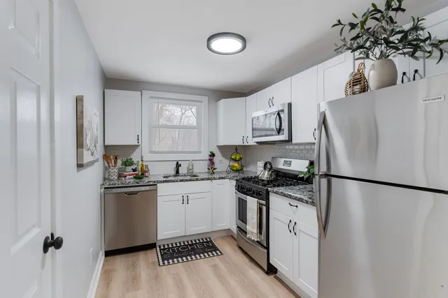 a kitchen with stainless steel appliances a refrigerator sink and cabinets
