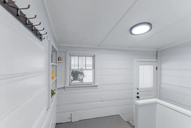 a living room with furniture and a floor to ceiling window