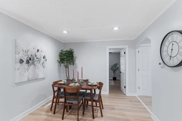 a view of a dining room with furniture and a potted plant