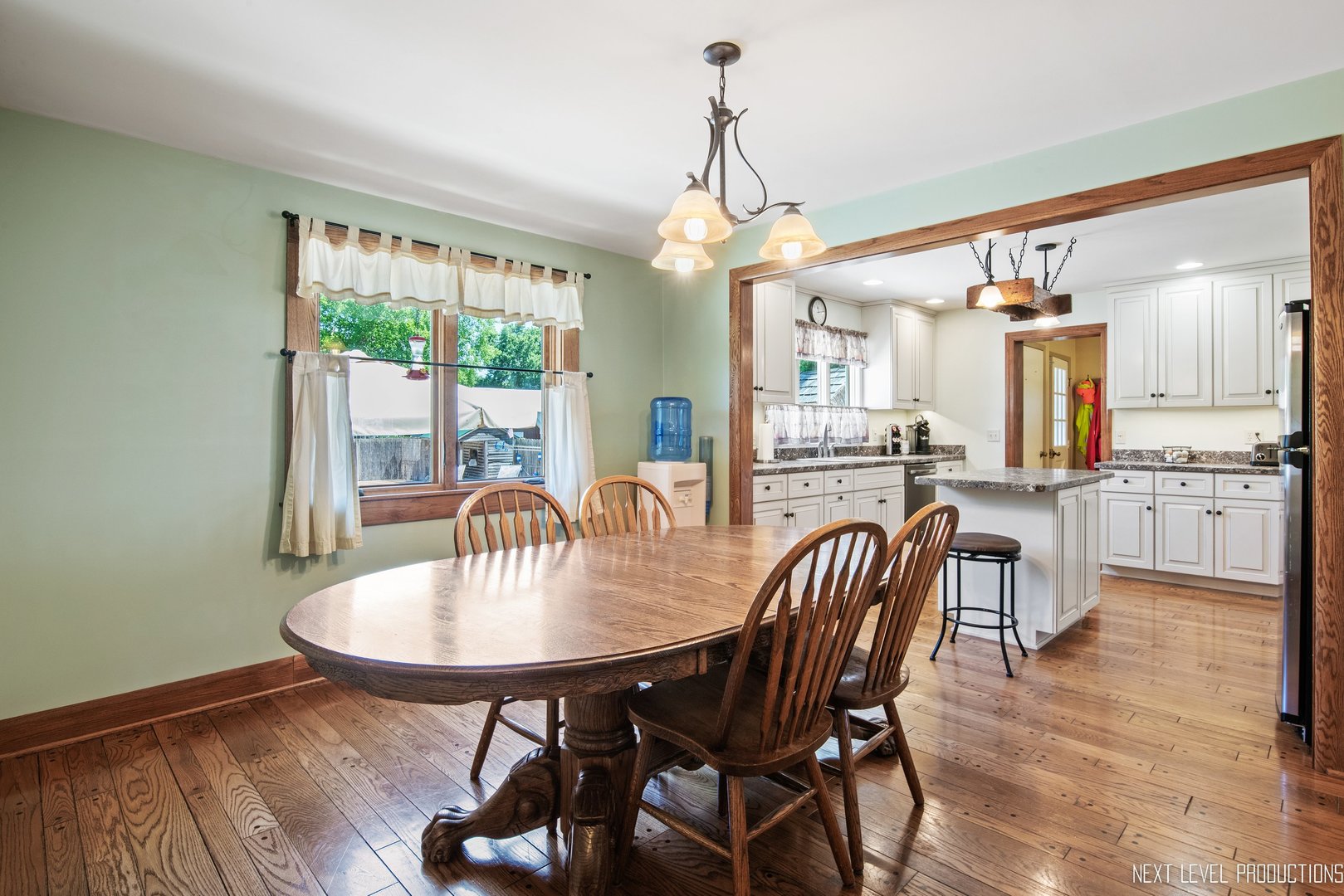 14815 Sears Road Plano, IL 60545 - Photo 24 of 30 a dining room with furniture a chandelier and wooden floor