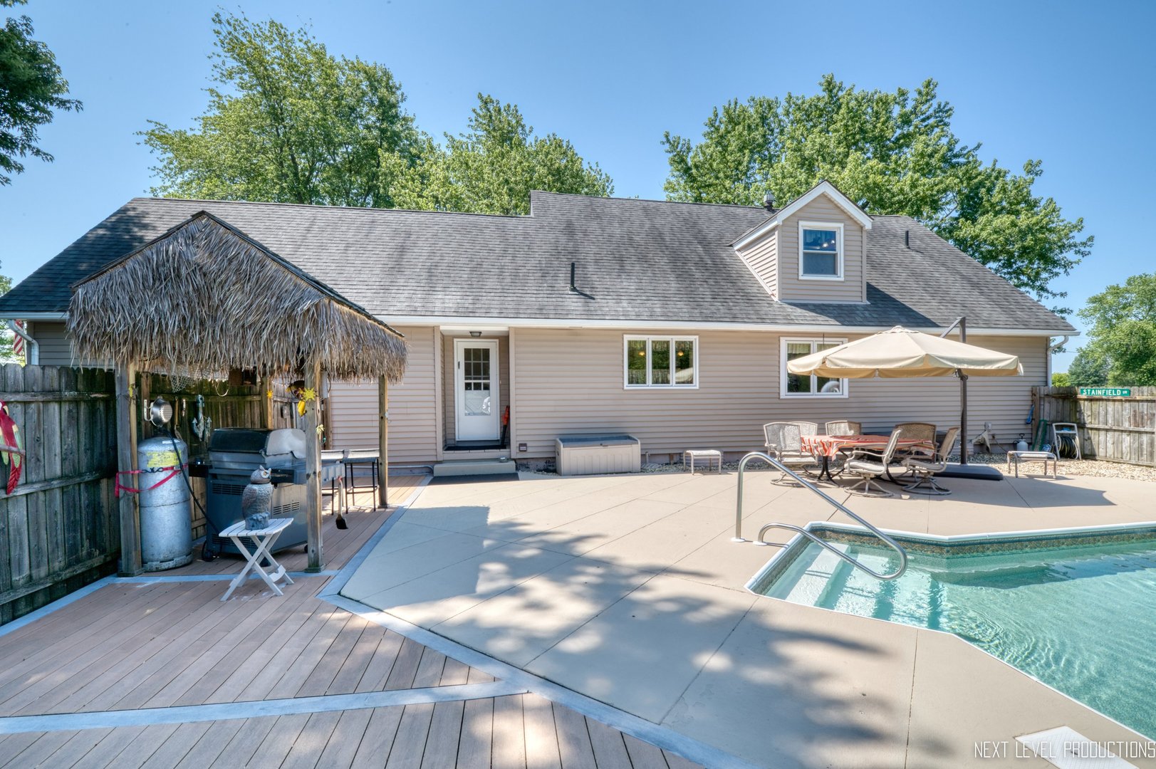 14815 Sears Road Plano, IL 60545 - Photo 6 of 30 a patio with a table and chairs under an umbrella