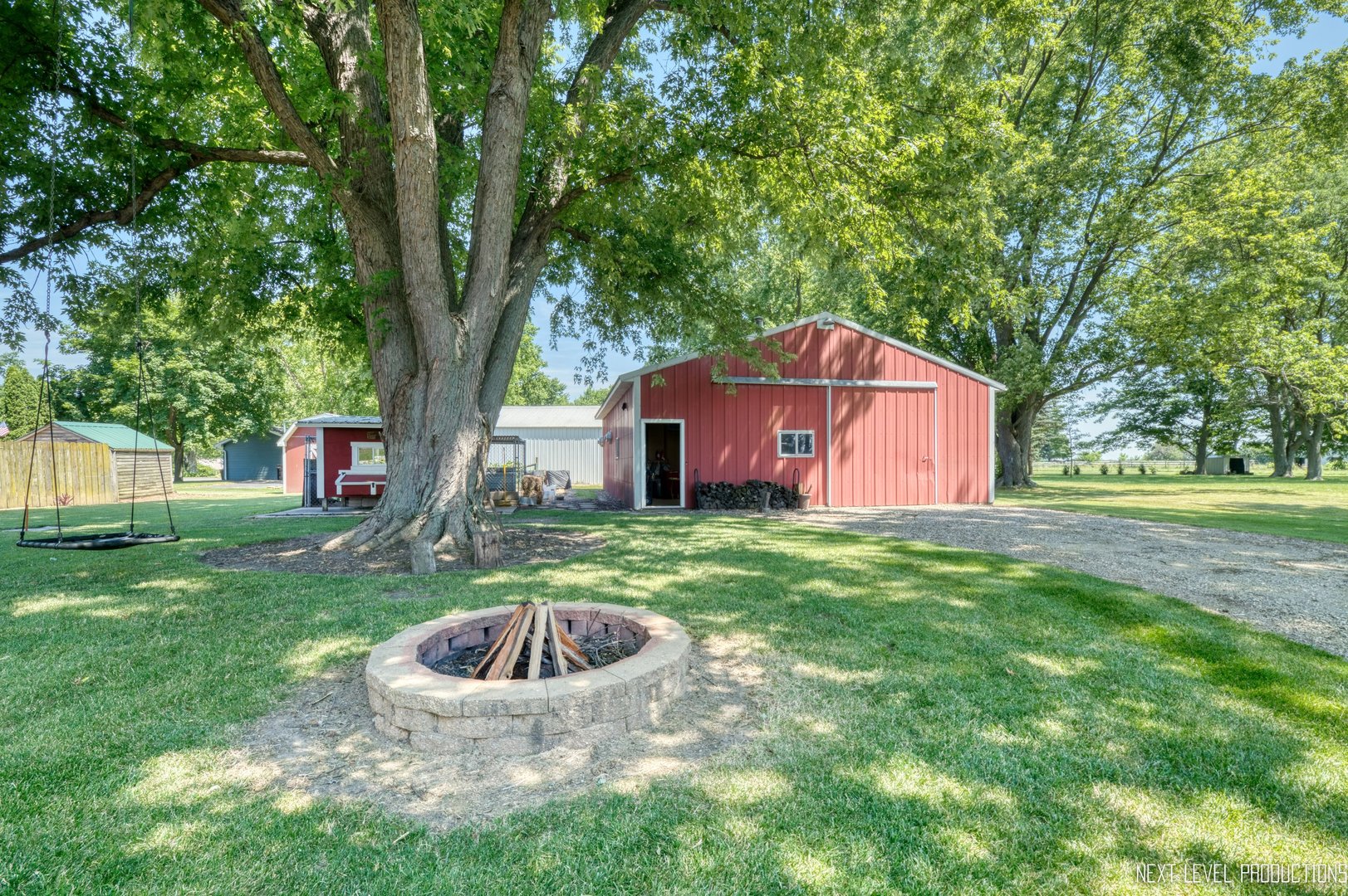 14815 Sears Road Plano, IL 60545 - Photo 9 of 30 a view of a backyard with potted plants and large trees