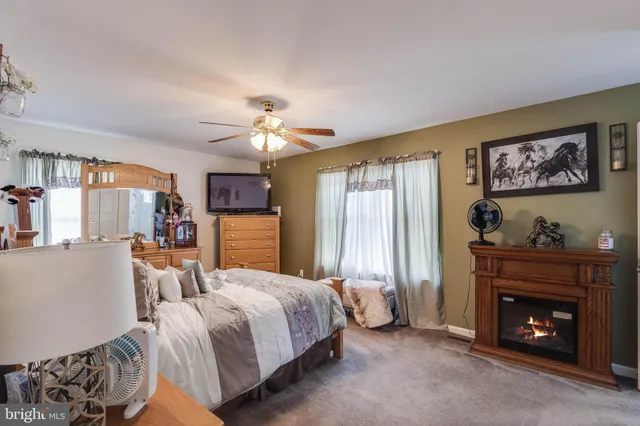 a bedroom with a bed and a fireplace